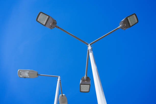 street lamps on a pole against a blue sky
